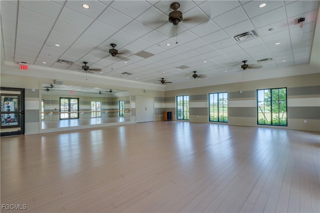 11768 Grand Belvedere Way, Unit 203 Fort Myers, FL 33913 - Photo 47 of 47 an empty room with wooden floor and windows