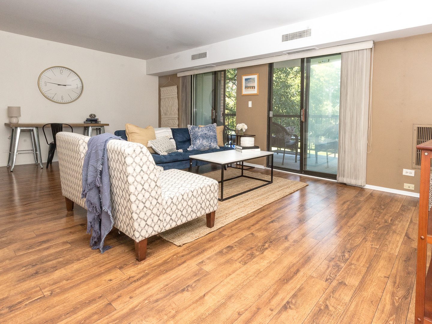 1605 East Central Road, Unit 203A Arlington Heights, IL 60005 - Photo 2 of 11 a living room with furniture and wooden floor