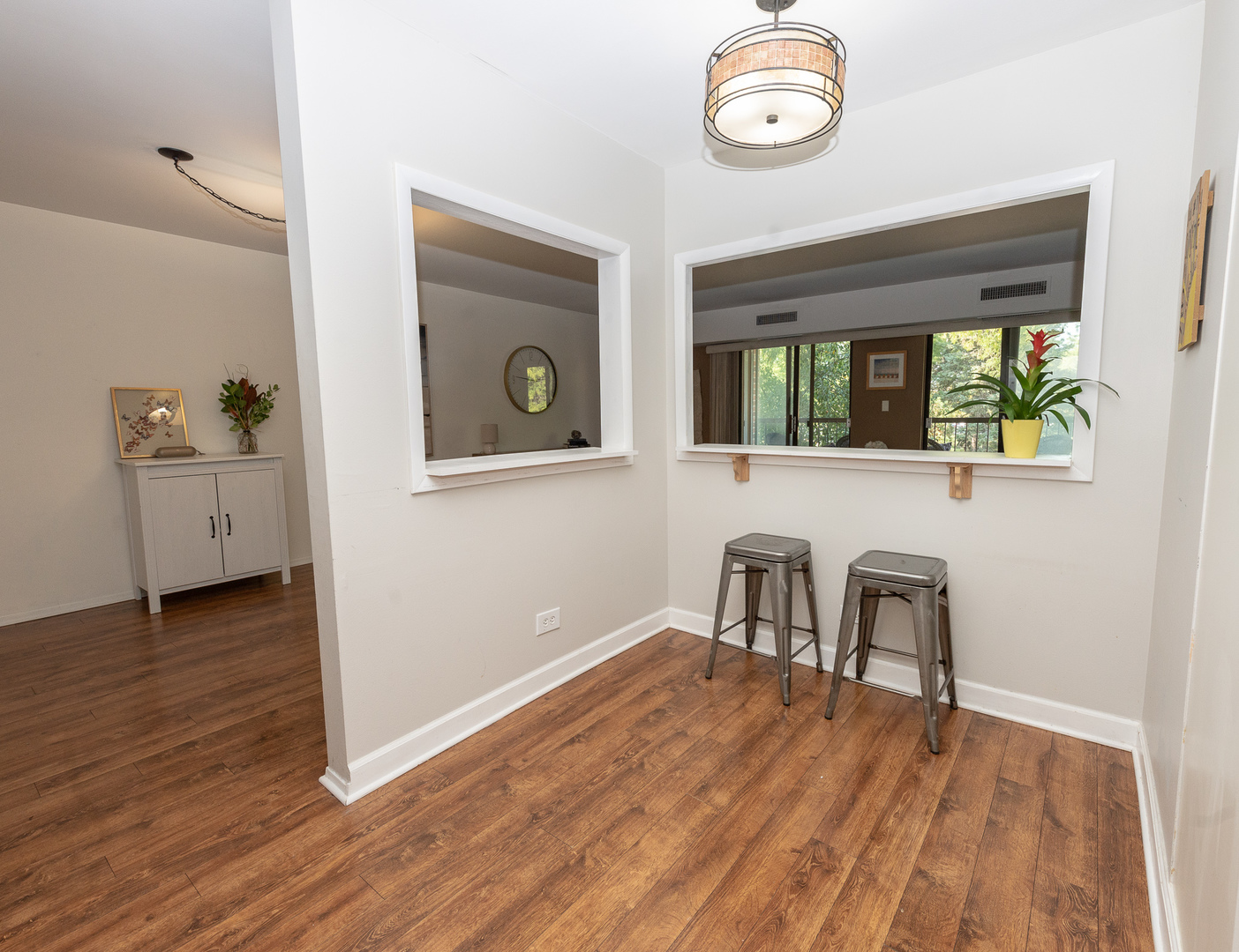 1605 East Central Road, Unit 203A Arlington Heights, IL 60005 - Photo 6 of 11 an empty room with windows and wooden floor