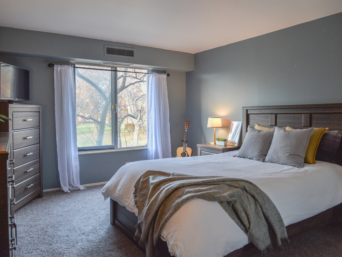 1605 East Central Road, Unit 203A Arlington Heights, IL 60005 - Photo 7 of 11 a spacious bedroom with a bed and a window