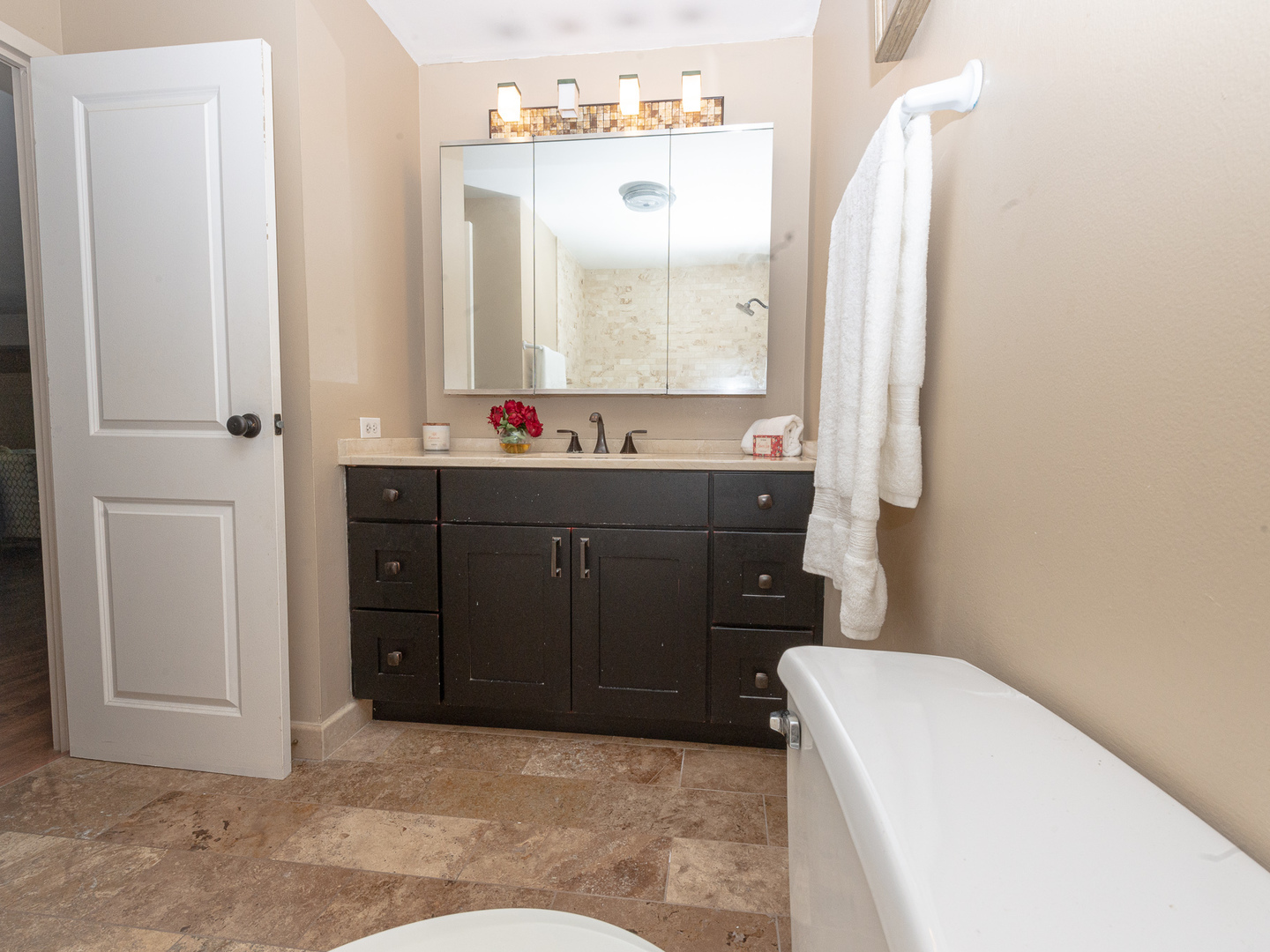 1605 East Central Road, Unit 203A Arlington Heights, IL 60005 - Photo 8 of 11 a bathroom with a sink a toilet and mirror