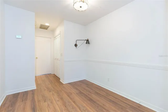 a view of a room with wooden floor