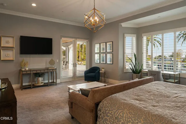 a bedroom with furniture and a flat screen tv