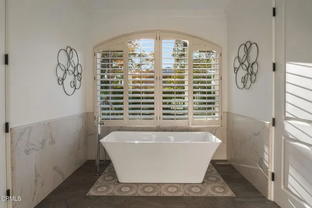 a spacious bedroom with a bed and a chandelier