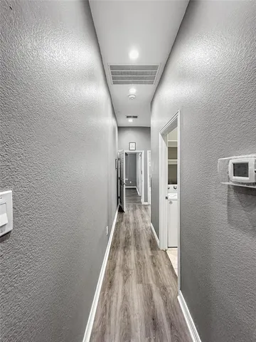 a kitchen with granite countertop white cabinets and stainless steel appliances