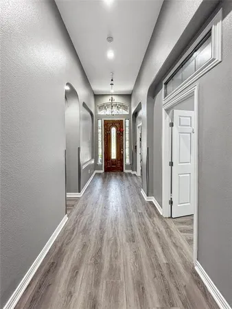 a view of hallway with wooden floor