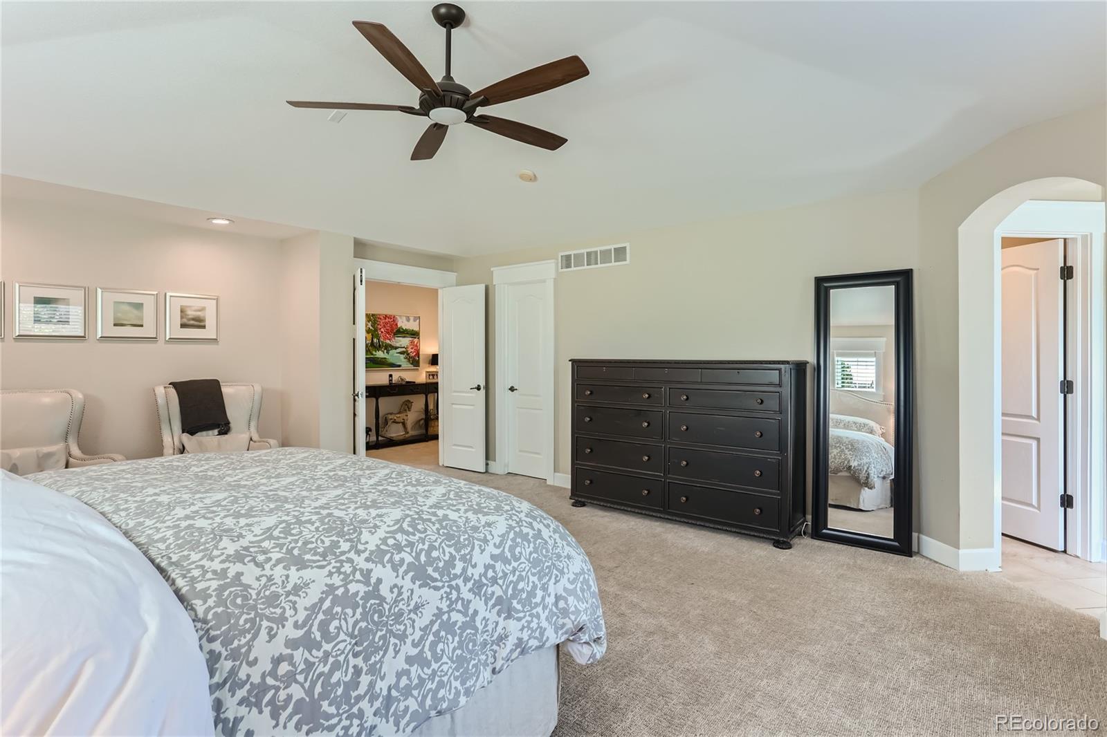 908 Syracuse Street Denver, CO 80230 - Photo 11 of 28 a bedroom with a bed and a dresser