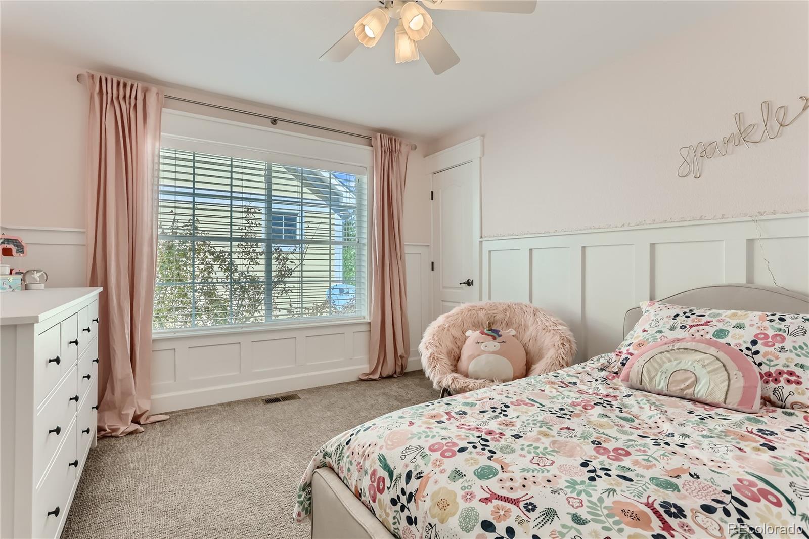 908 Syracuse Street Denver, CO 80230 - Photo 14 of 28 a bedroom with a bed and a chandelier