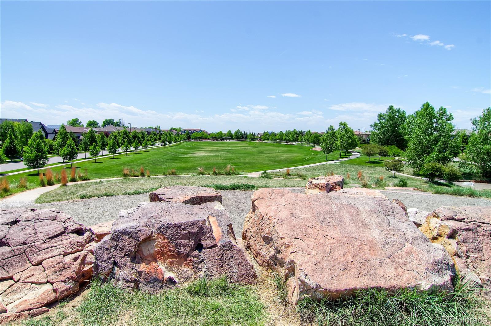 908 Syracuse Street Denver, CO 80230 - Photo 28 of 28 a view of a street with a big yard and potted plants