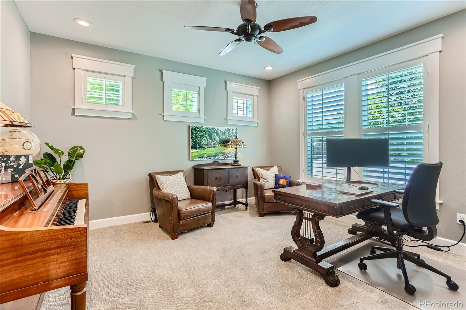 908 Syracuse Street Denver, CO 80230 - Photo 3 of 28 a view of a workspace with furniture and a window