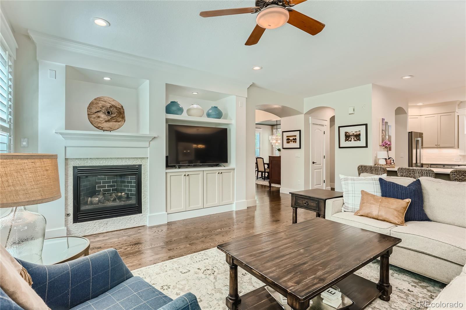 908 Syracuse Street Denver, CO 80230 - Photo 4 of 28 a living room with furniture and a fireplace