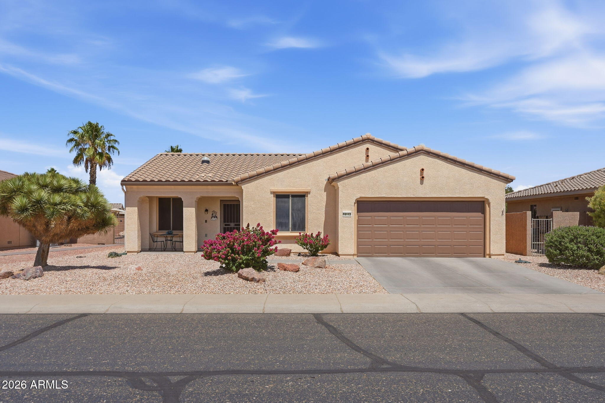 19113 North Hunters Run Surprise, AZ 85387 - Photo 1 of 45 a front view of a house with a outdoor space