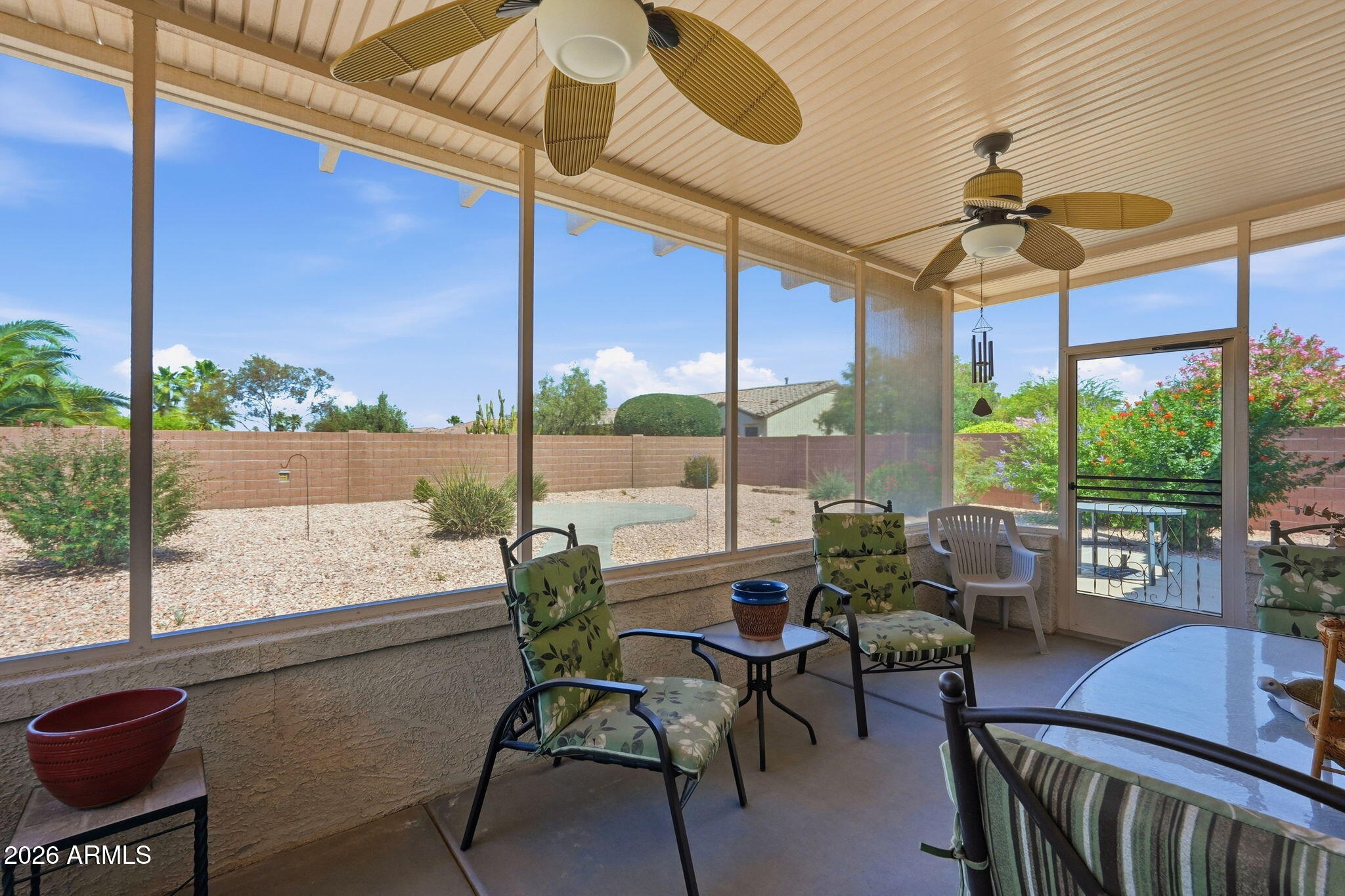 19113 North Hunters Run Surprise, AZ 85387 - Photo 16 of 45 a view of a patio with a table chairs and a potted plant