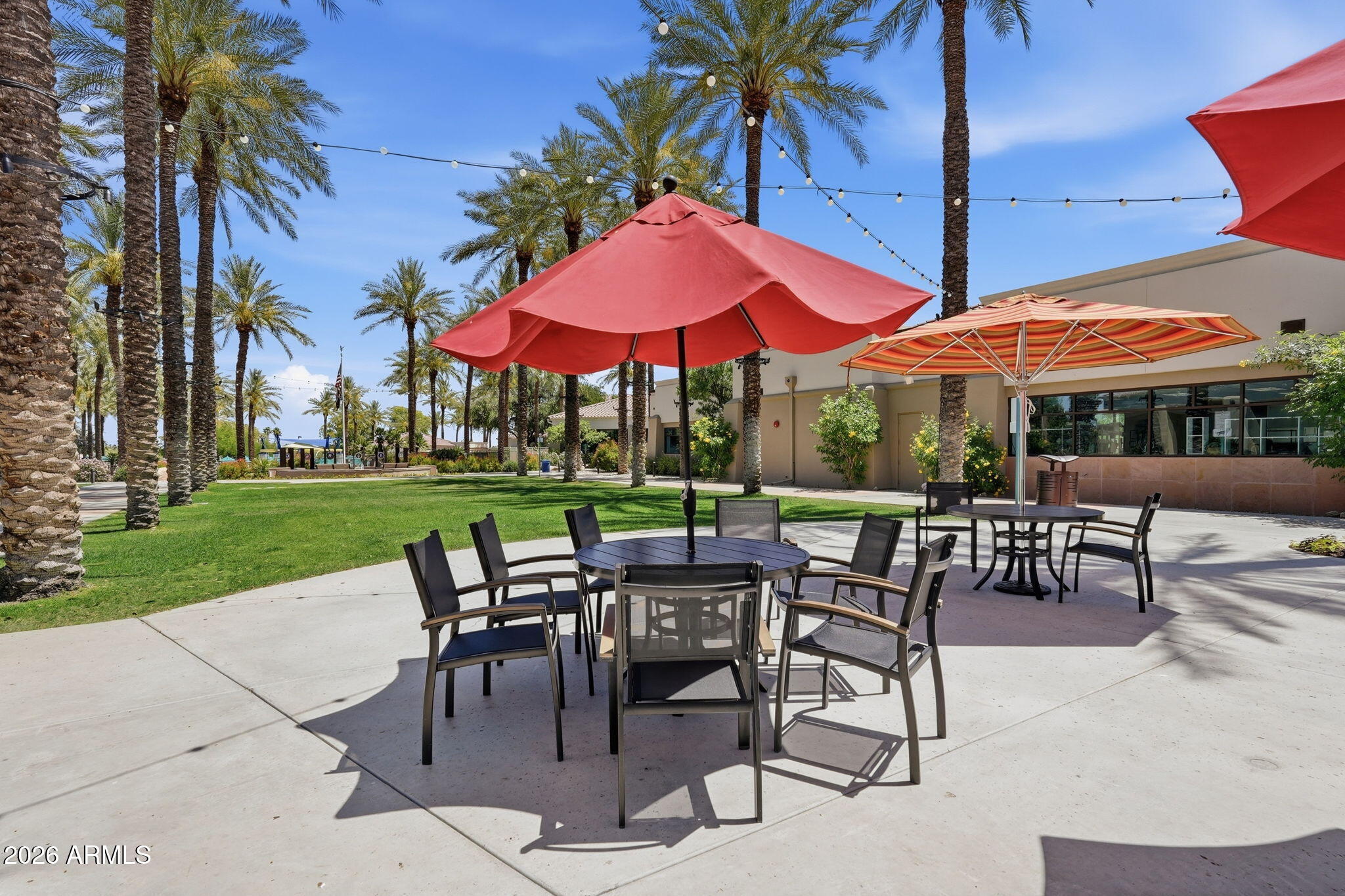 19113 North Hunters Run Surprise, AZ 85387 - Photo 41 of 45 a view of patio with chairs and tables with a umbrella