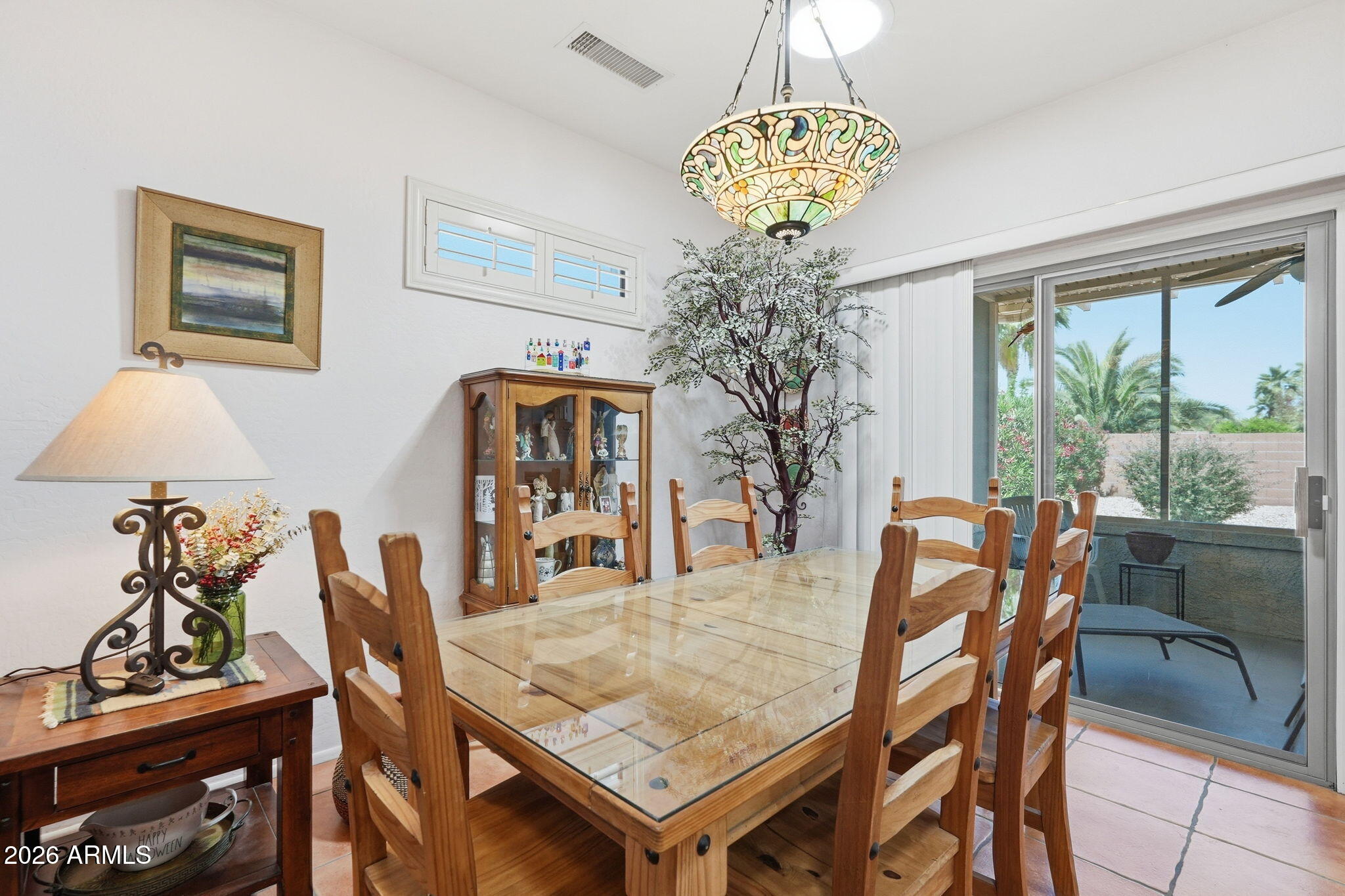 19113 North Hunters Run Surprise, AZ 85387 - Photo 5 of 45 a dining room table lamp and a chandelier