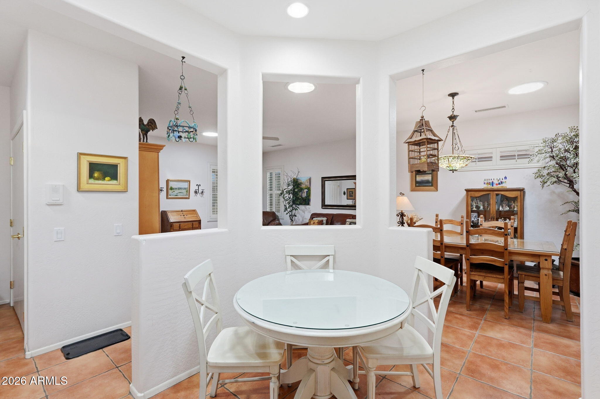 19113 North Hunters Run Surprise, AZ 85387 - Photo 6 of 45 a dining room with table chairs and kitchen view
