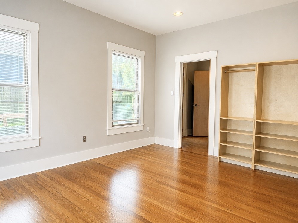 4530 Walker Street Houston, TX 77023 - Photo 8 of 17 an empty room with wooden floor and windows