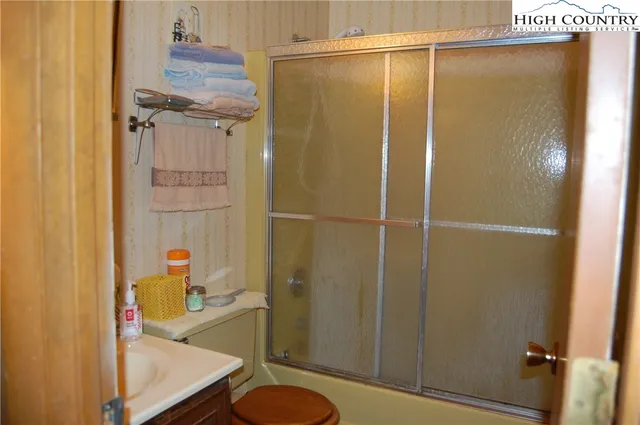 a bathroom with a shower and a sink