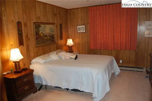 a bedroom with a bed and a potted plant