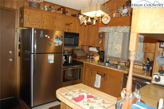 a kitchen with cabinets a refrigerator and a stove