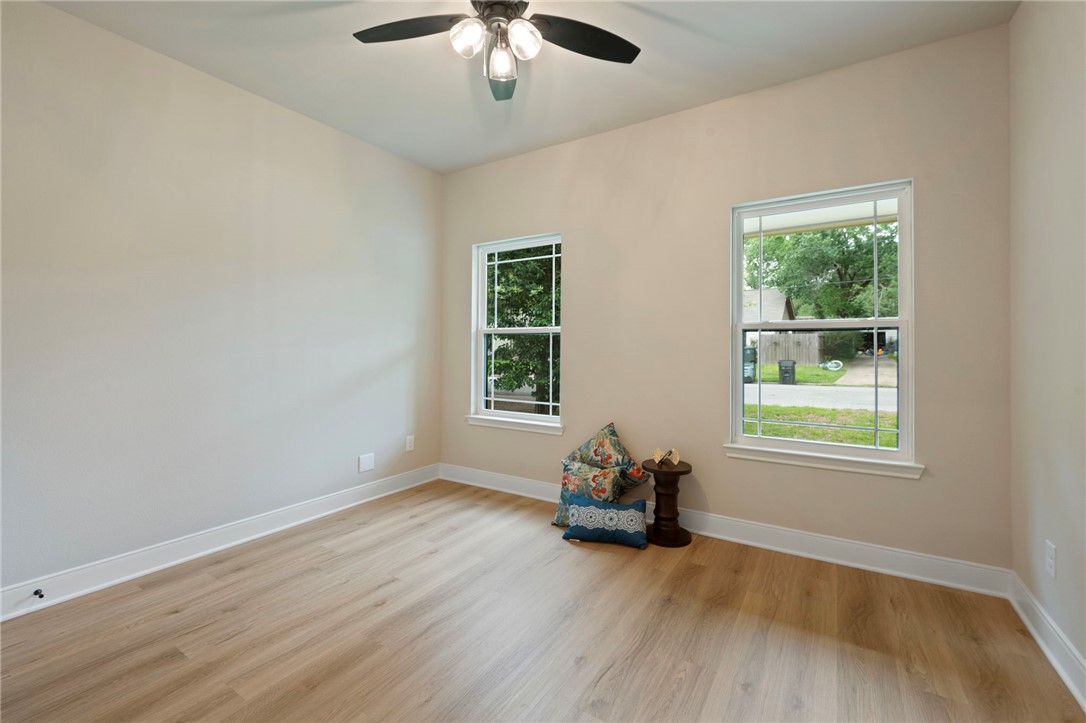 804 East 27th Street Bryan, TX 77803 - Photo 10 of 21 a view of an empty room with wooden floor and a window