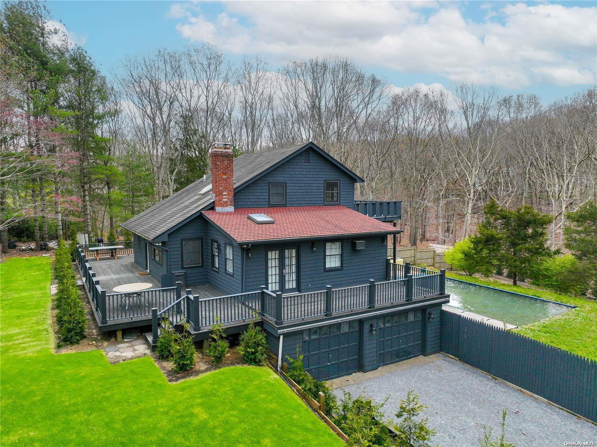 115 Harrison Avenue East Hampton, NY 11937 - Photo 1 of 1 a view of a house with a yard potted plants and a bench