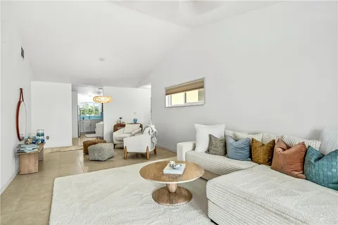 a living room with furniture and a lamp