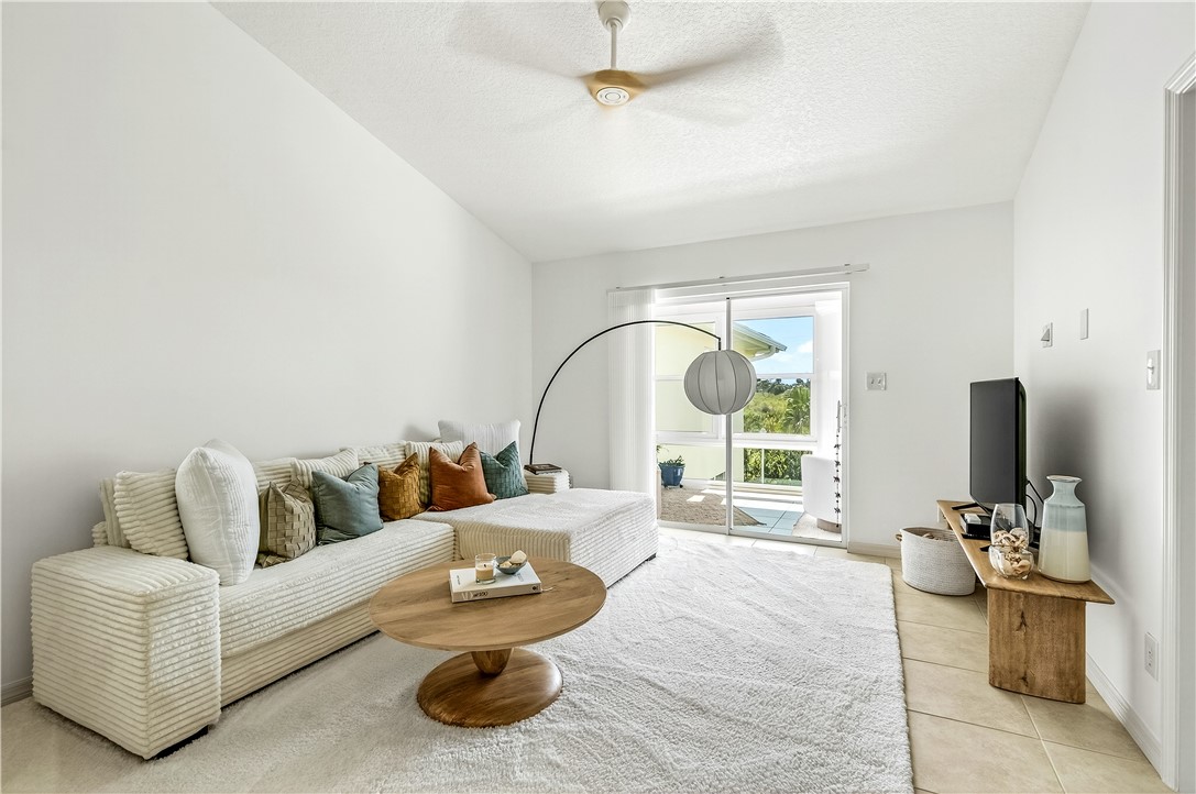 475 Grove Isle Circle, Unit 475 Vero Beach, FL 32962 - Photo 13 of 36 a living room with furniture and a large window