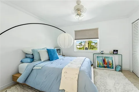 a bed sitting in a bedroom next to a window