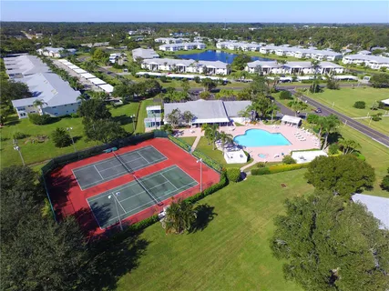 an aerial view of residential houses with outdoor space and swimming pool