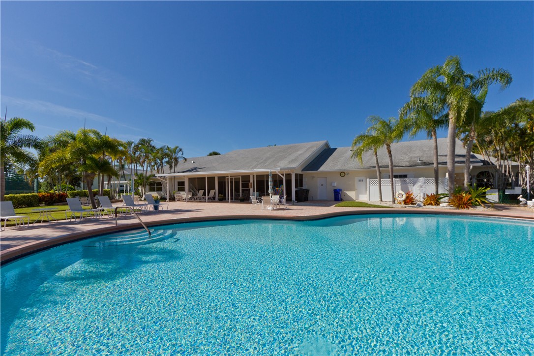 475 Grove Isle Circle, Unit 475 Vero Beach, FL 32962 - Photo 22 of 36 a view of a house with swimming pool and sitting area