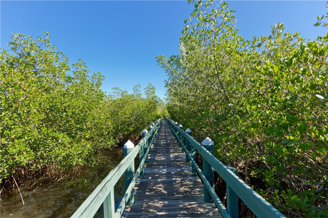 475 Grove Isle Circle, Unit 475 Vero Beach, FL 32962 - Photo 34 of 36 a view of a house with a flower garden