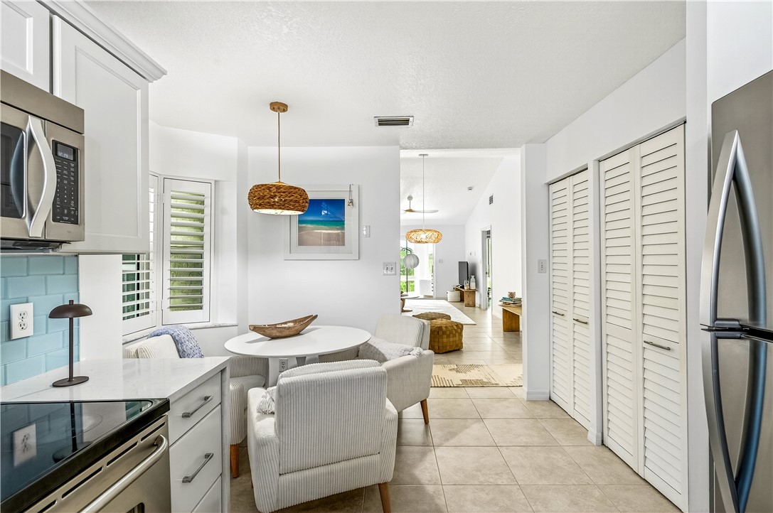 475 Grove Isle Circle, Unit 475 Vero Beach, FL 32962 - Photo 9 of 36 a kitchen with a sink stove and refrigerator