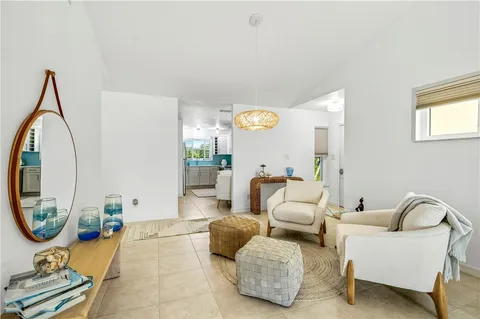 a living room with furniture and a large mirror