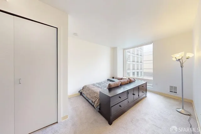 a spacious bedroom with a bed and a window in it