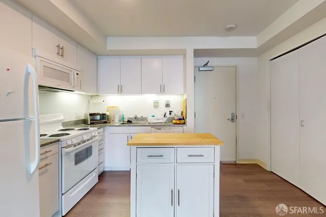 a kitchen with a stove a sink and a refrigerator