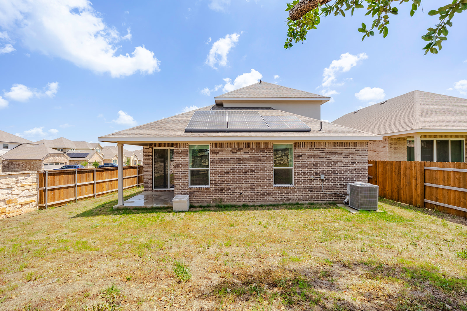 900 Balsora Cove Georgetown, TX 78628 - Photo 30 of 39 A private backyard oasis with solar panels and a sheltered patio offers a peaceful outdoor retreat.