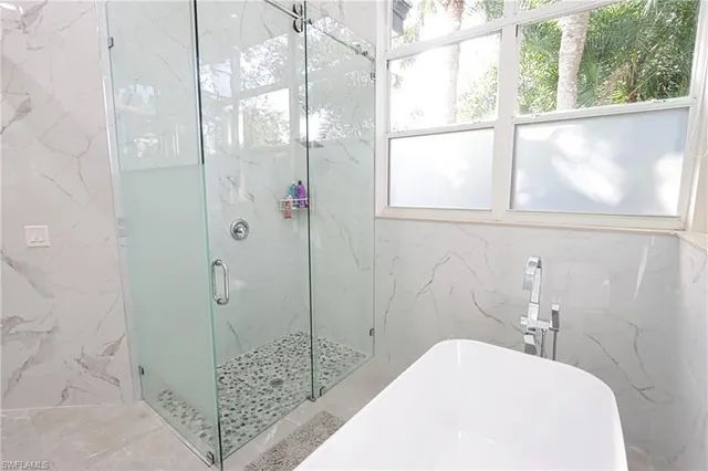 a bathroom with a bathtub and shower