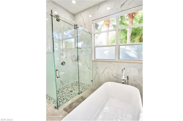 a bathroom with a bathtub and a shower