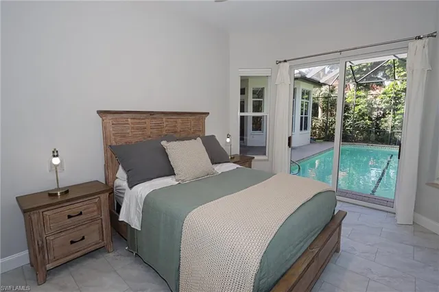 a bedroom with a bed and large window