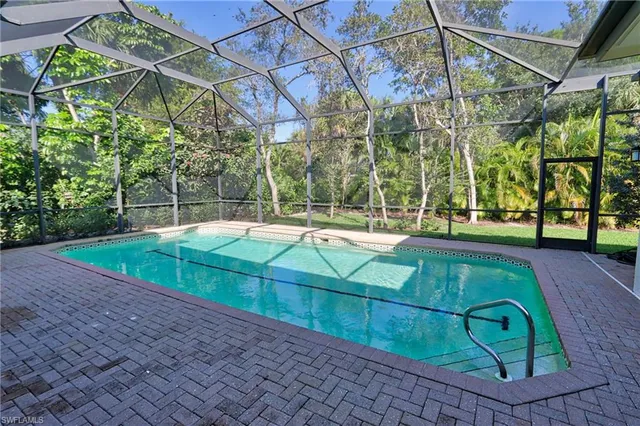 a view of a backyard with a patio and a yard