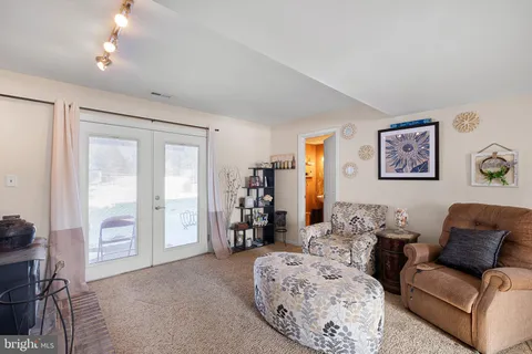 a living room with furniture and a chandelier