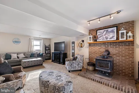 a living room with furniture windows and a flat screen tv