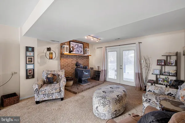 a living room with furniture large window and wooden floor