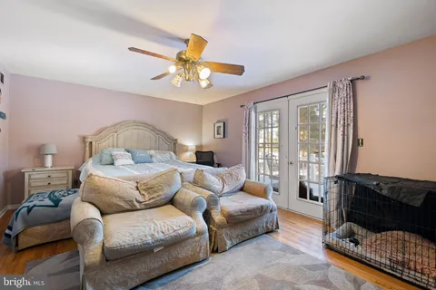 a bedroom with furniture and a large window