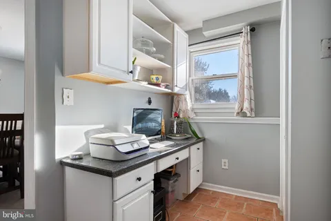 a kitchen with a sink cabinets and a window