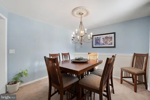 a view of a dining room with furniture and chandelier