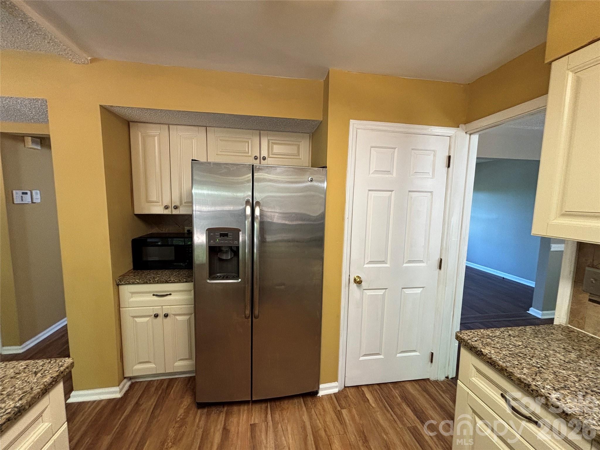 2601 Yarrow Road Charlotte, NC 28213 - Photo 14 of 40 a kitchen with a refrigerator and wooden floor