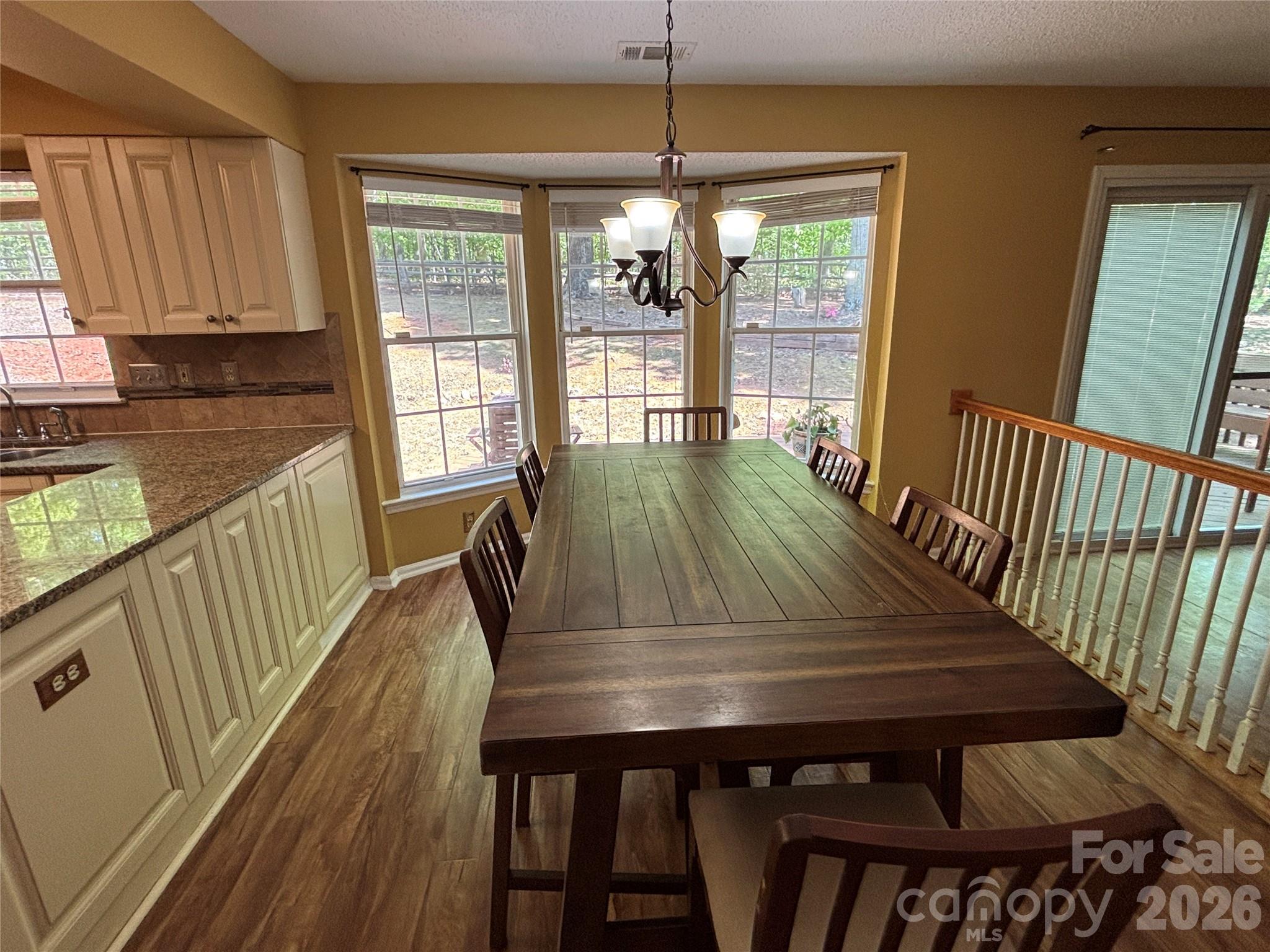 2601 Yarrow Road Charlotte, NC 28213 - Photo 15 of 40 a view of a dining room with furniture window and wooden floor