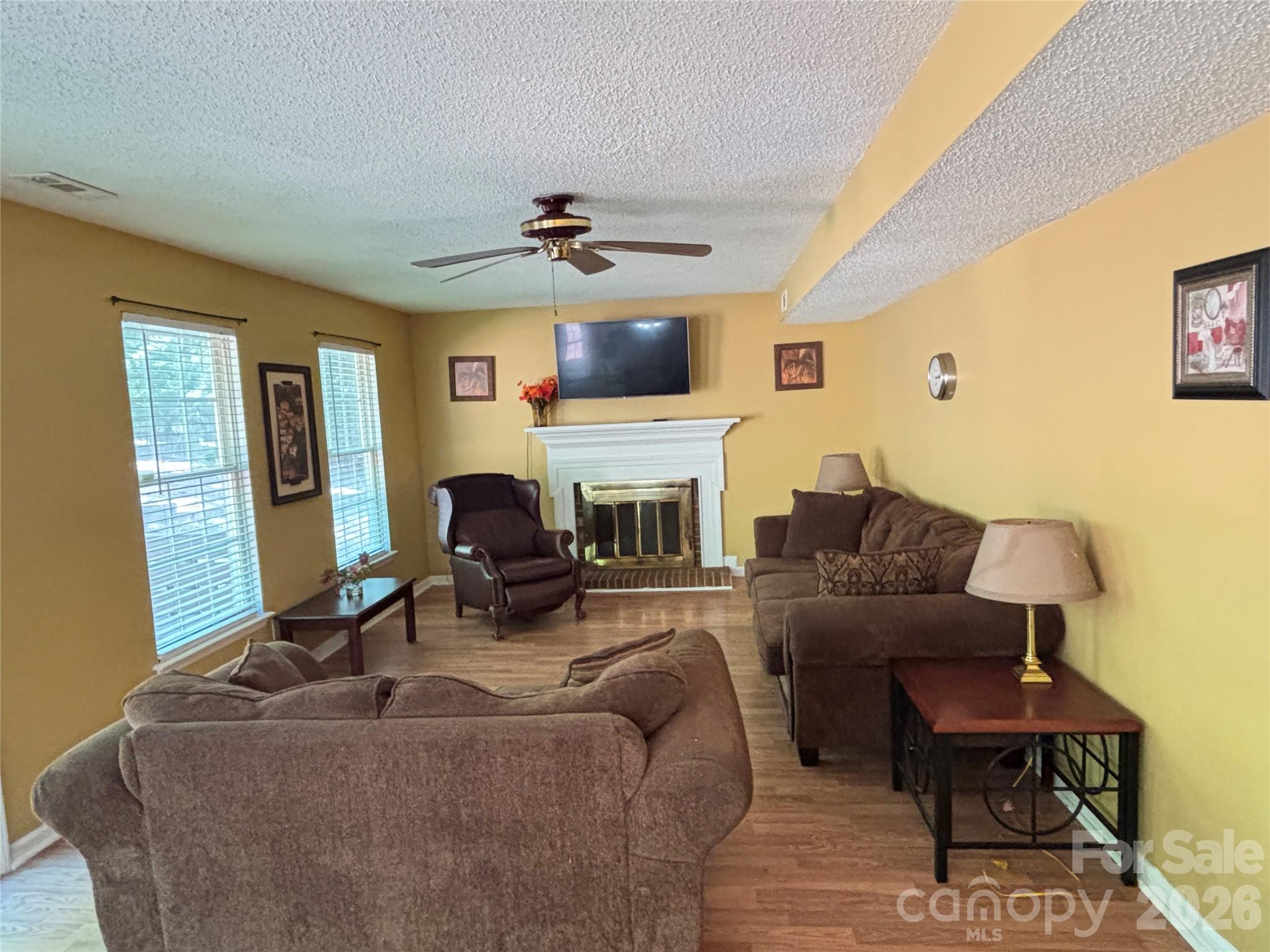 2601 Yarrow Road Charlotte, NC 28213 - Photo 17 of 40 a living room with furniture a fireplace and a flat screen tv
